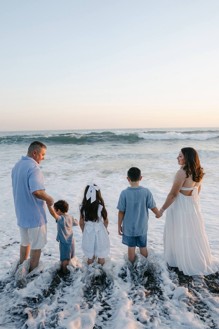 Family facing the ocean