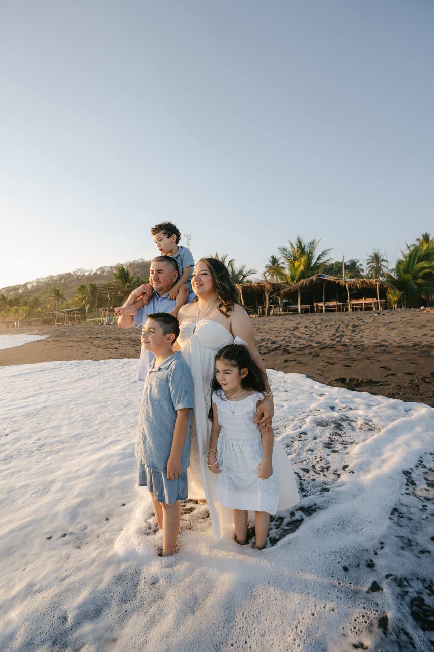 Family with waves at feet
